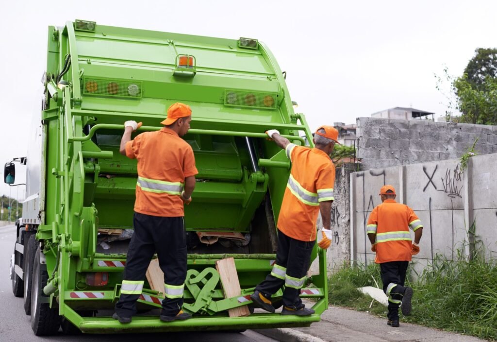 Waste bags being carried to a collection truck